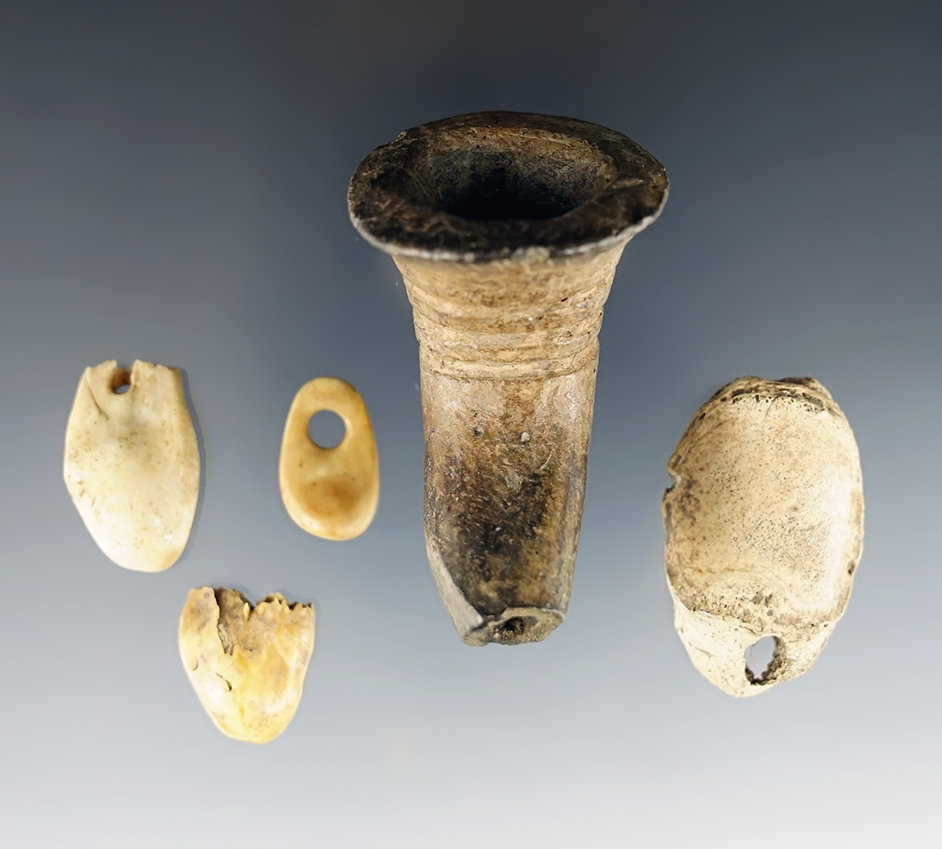 Set of site material including a salvaged Ring Bowl Pipe and drilled Elk Teeth. New York.