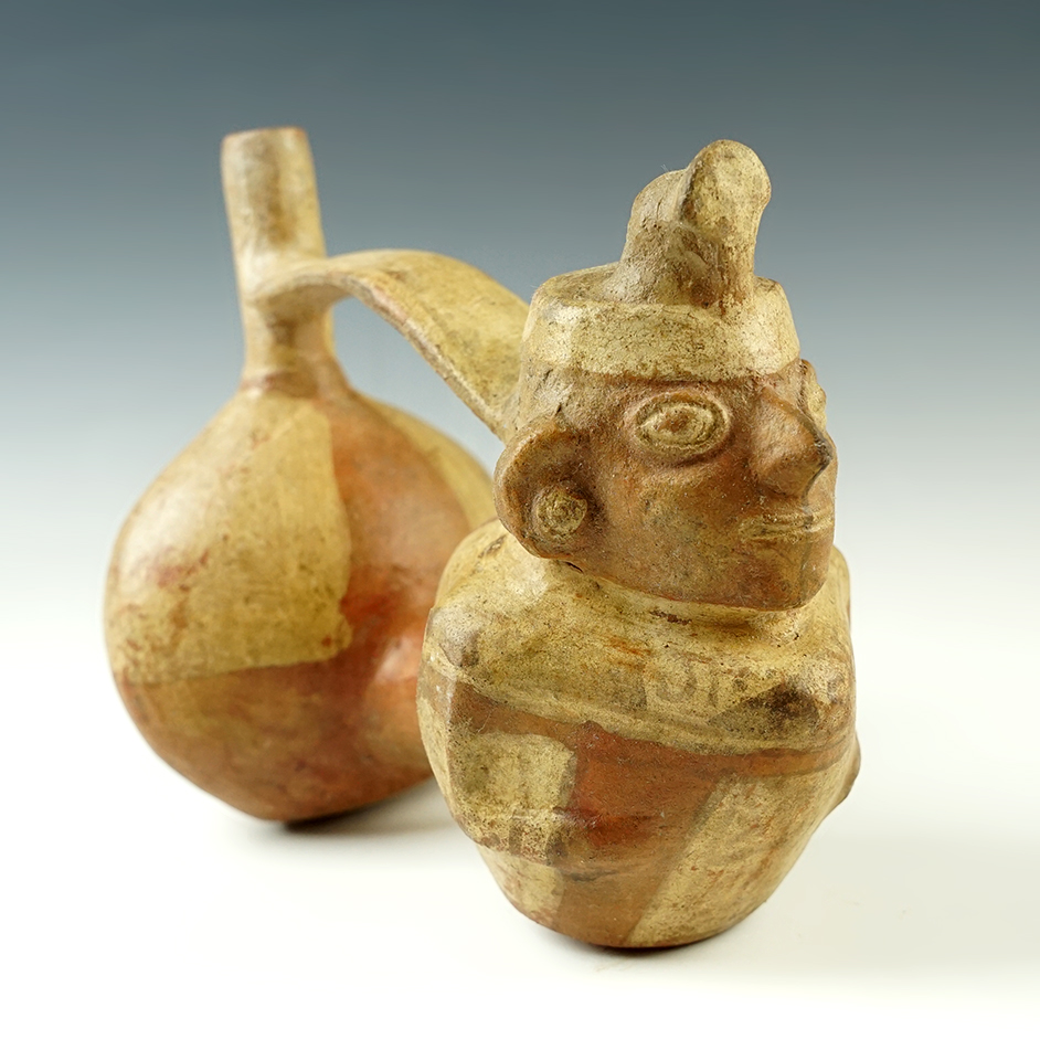 7 1/2" wide x 6 1/2" tall Peru Stirrup Vessel with human figure, small spots of restoration.