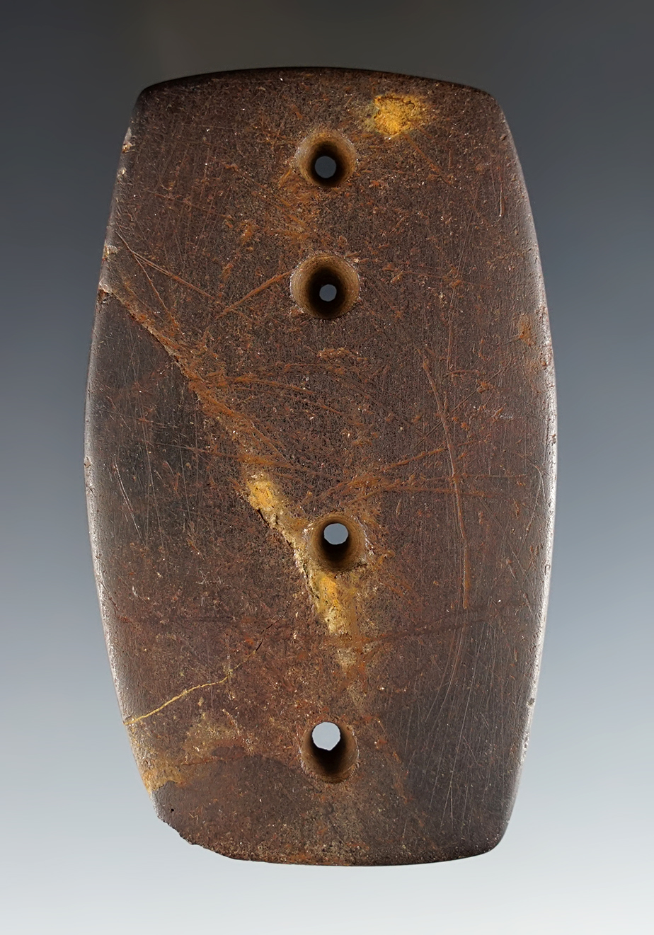 3 11/16" 4-hole Gorget from brown Slate. Recovered in Ohio. Ohio Archaeologist Magazine.