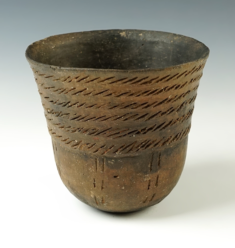 4 7/8" wide x  4 5/8" tall Caddo Incised Jar with a flared rim. Recovered in Bowie Co., Texas.