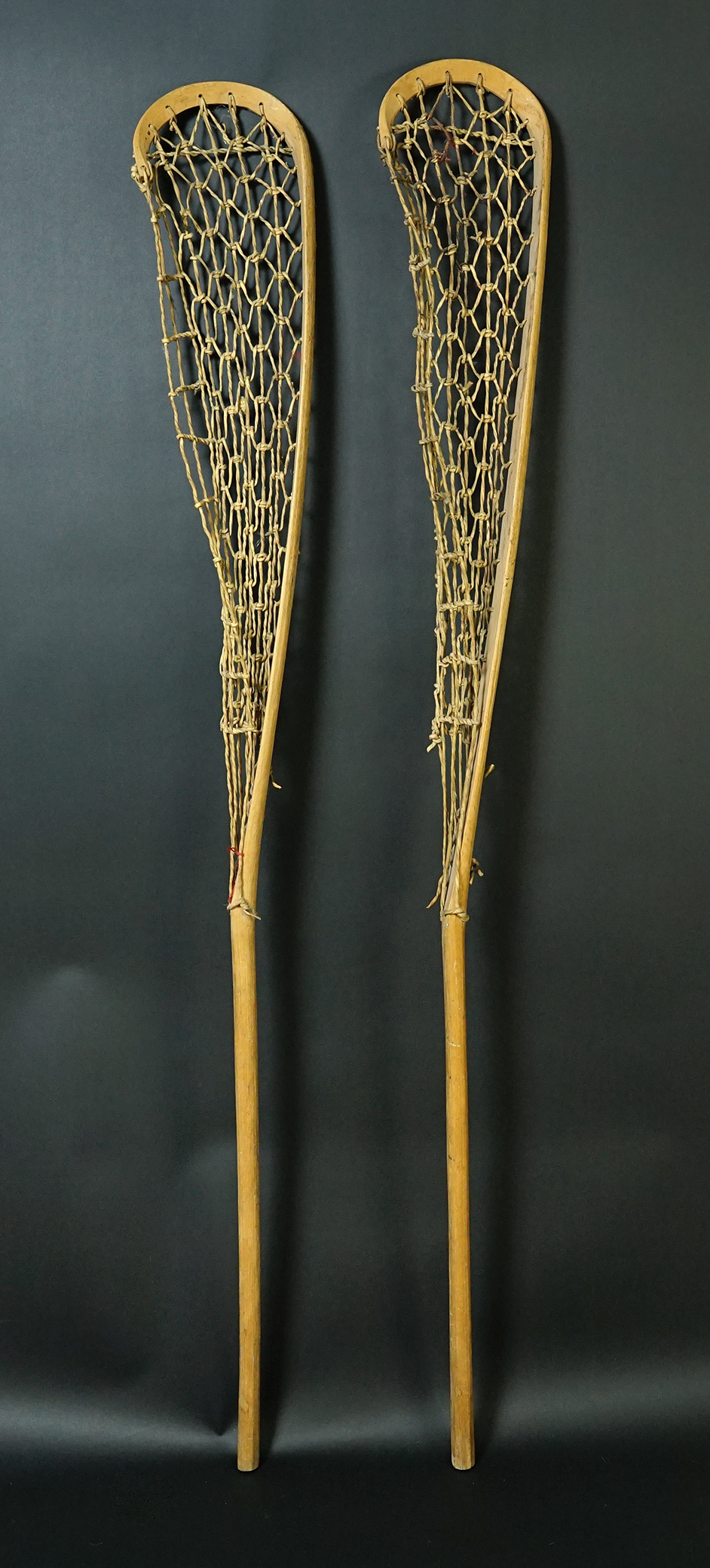 Pair of vintage 61 1/2" Lacrosse Sticks with rawhide netting, in excellent condition.