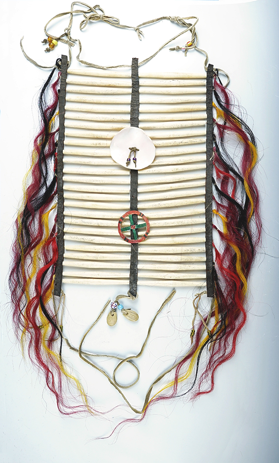 15" x 9" Chest Plate made from leather, drilled elk teeth and colored horse hair.