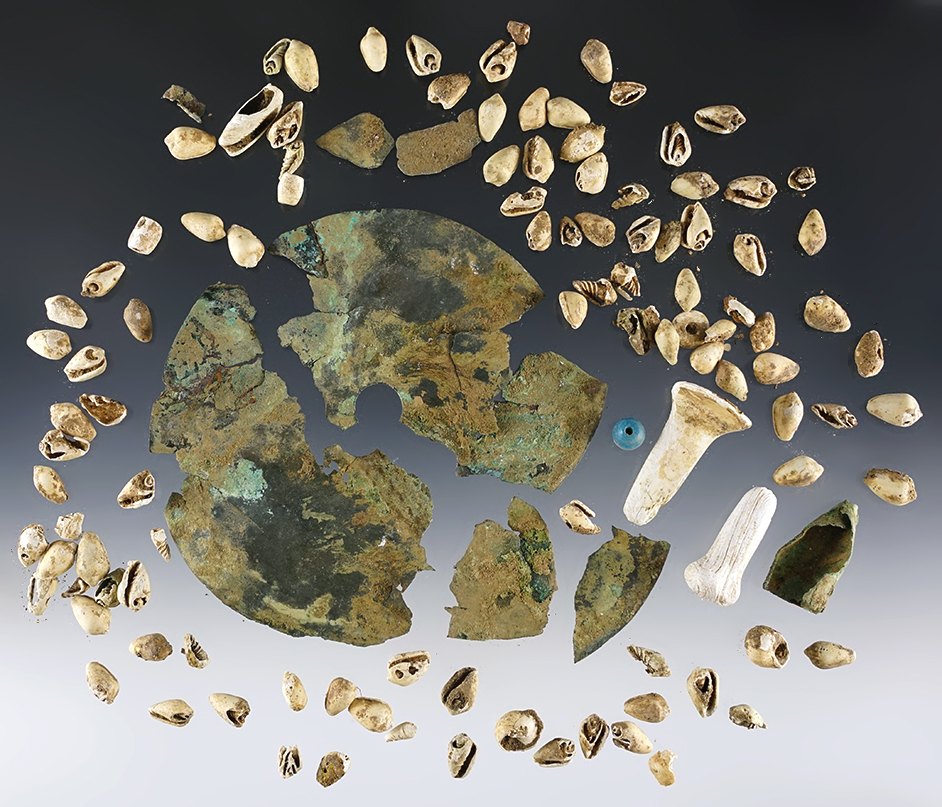 Snail Shell Beads, two Shell Facial Ornaments and remnant of a Copper Gorget. Tennessee.