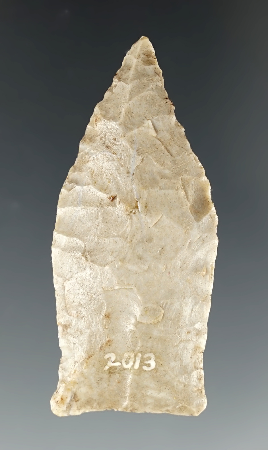 2" lightly fluted Paleo point with nicely ground lower edges recovered in Kentucky.